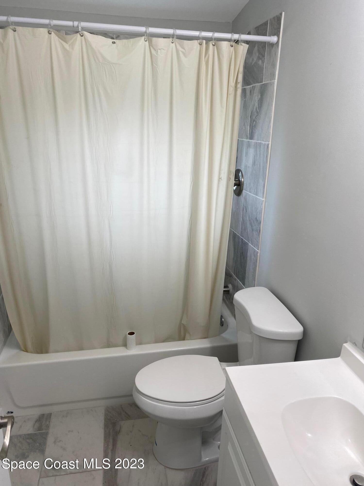 2944 Century Oaks Circle Malabar, FL 32950 - Photo 13 of 16 a white toilet sitting next to a shower
