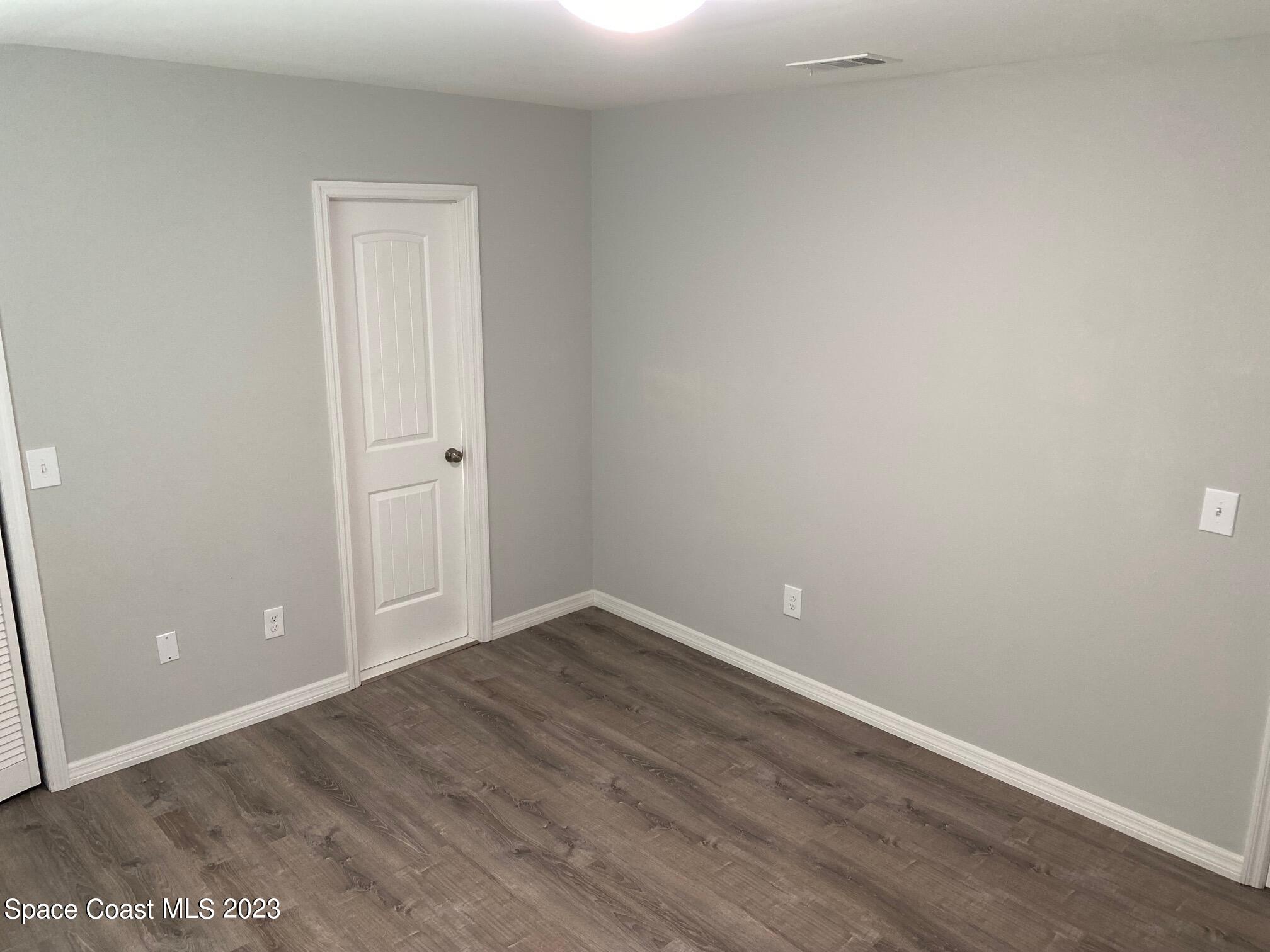 2944 Century Oaks Circle Malabar, FL 32950 - Photo 16 of 16 a view of an empty room with wooden floor and closet