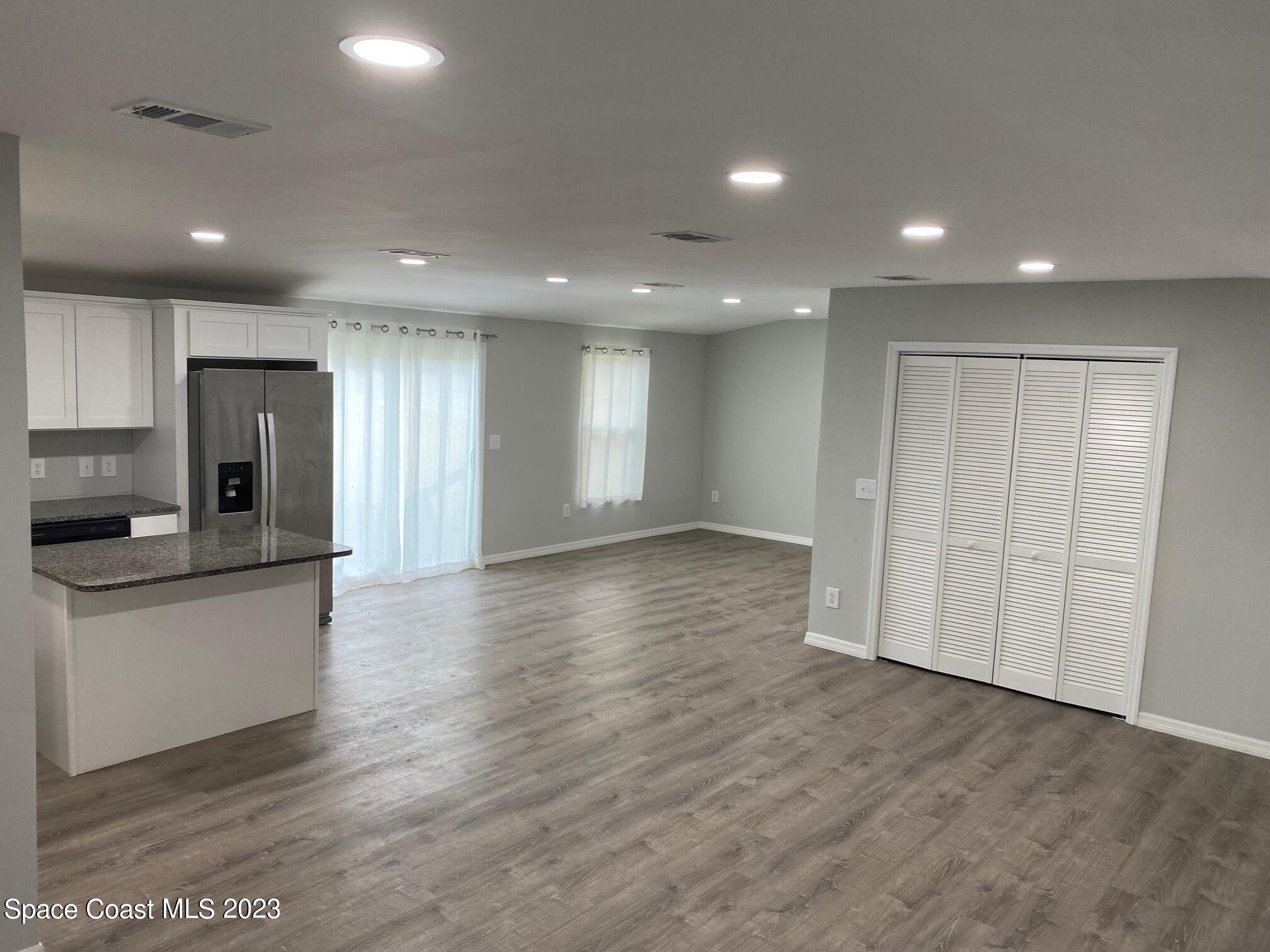 2944 Century Oaks Circle Malabar, FL 32950 - Photo 4 of 16 a view of a kitchen with a sink and a refrigerator