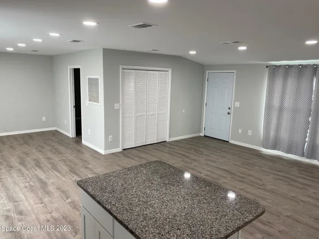 an empty room with wooden floor