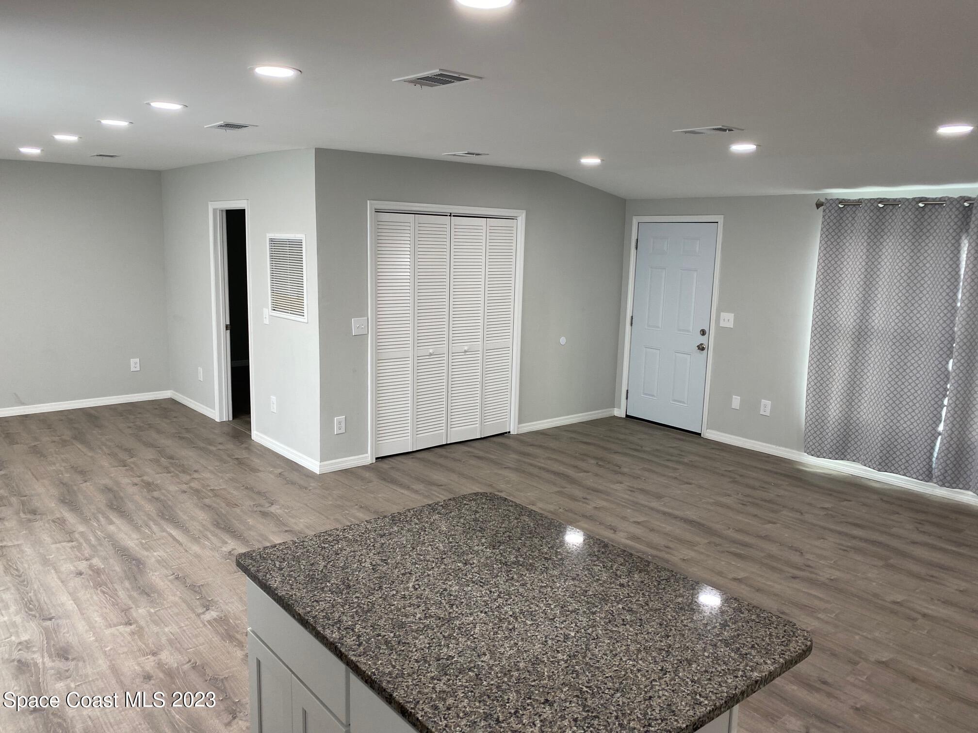 2944 Century Oaks Circle Malabar, FL 32950 - Photo 5 of 16 an empty room with wooden floor
