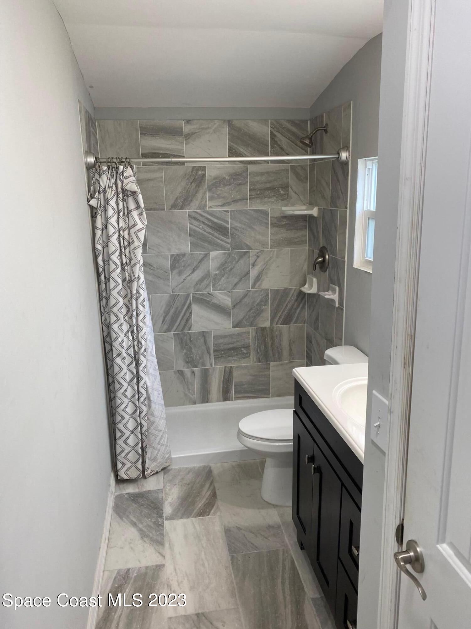 2944 Century Oaks Circle Malabar, FL 32950 - Photo 7 of 16 a bathroom with a toilet a sink and shower