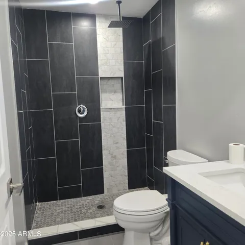 a bathroom with a toilet and a shower