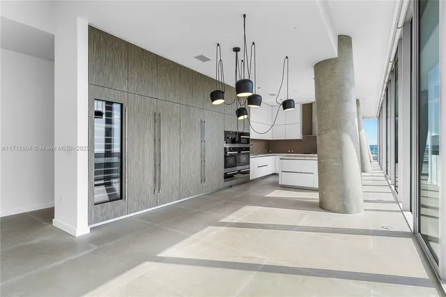 a view of a hallway with a kitchen