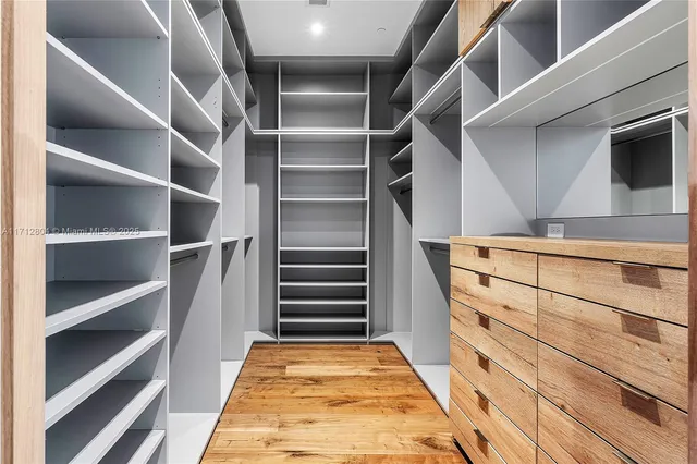 a view of walk in closet with empty racks