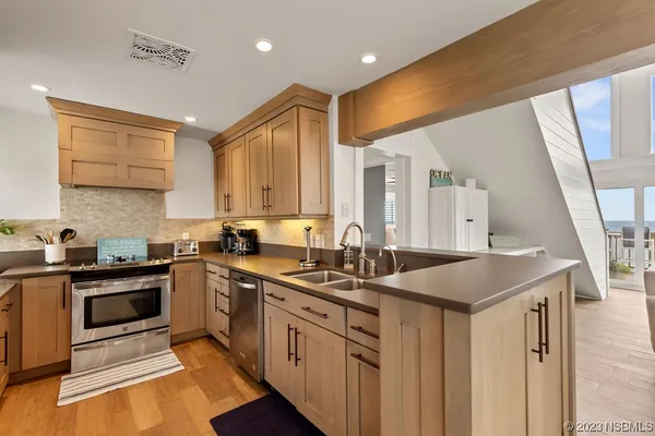 a kitchen with a sink stove and cabinets
