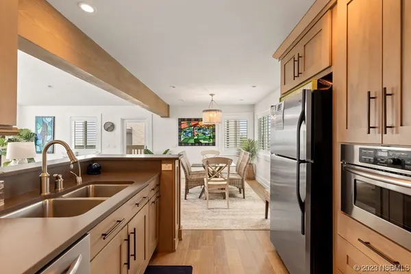 a kitchen with stainless steel appliances granite countertop a sink refrigerator and cabinets