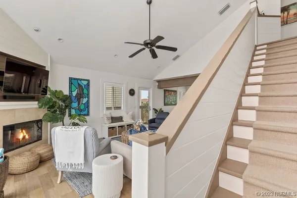 a living room with furniture a flat screen tv and a fireplace