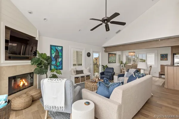 a living room with furniture a fireplace and a flat screen tv