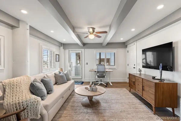 a living room with furniture and wooden floor