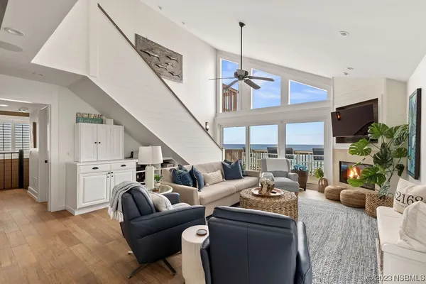 a living room with furniture a fireplace and a flat screen tv