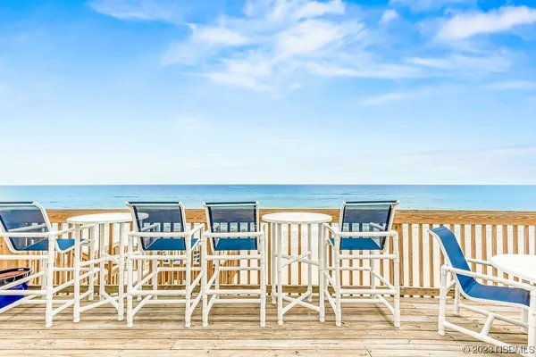 a view of a balcony with chairs