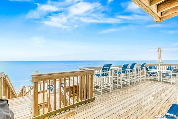 a view of a balcony with table and chairs