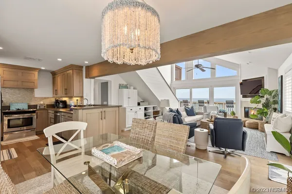 a living room with lots of furniture and a chandelier