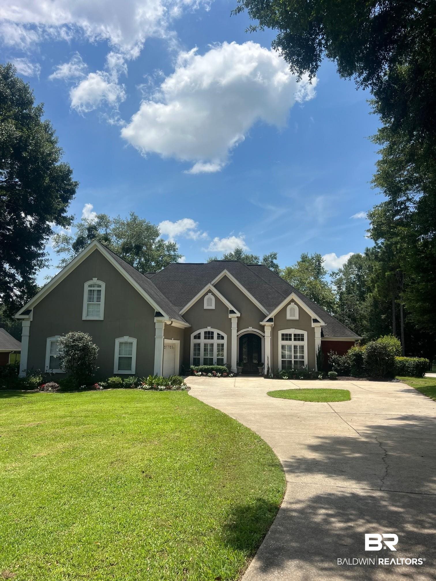 8775 Dawes Lake Road North Mobile, AL 36619 - Photo 5 of 59 View of front facade with concrete driveway, stucco siding, a front yard, and a garage