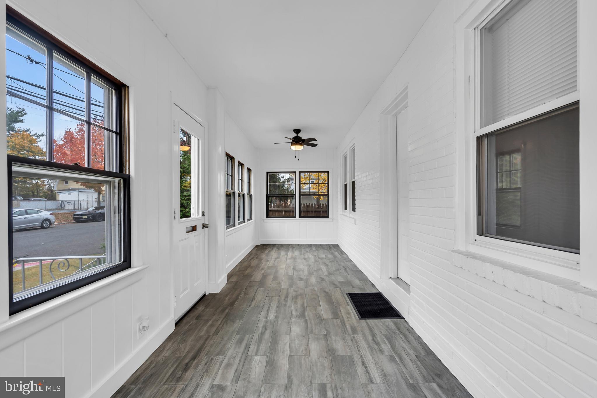29 Saybrook Avenue Trenton, NJ 08619 - Photo 14 of 31 a view of a hallway with wooden floor and windows
