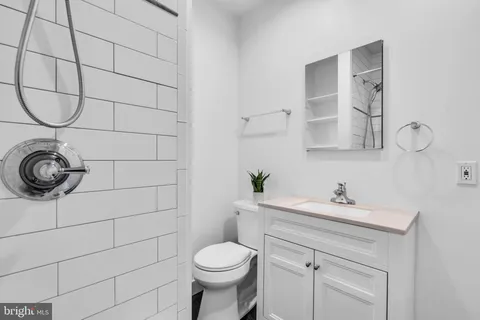 a bathroom with a sink toilet and a mirror