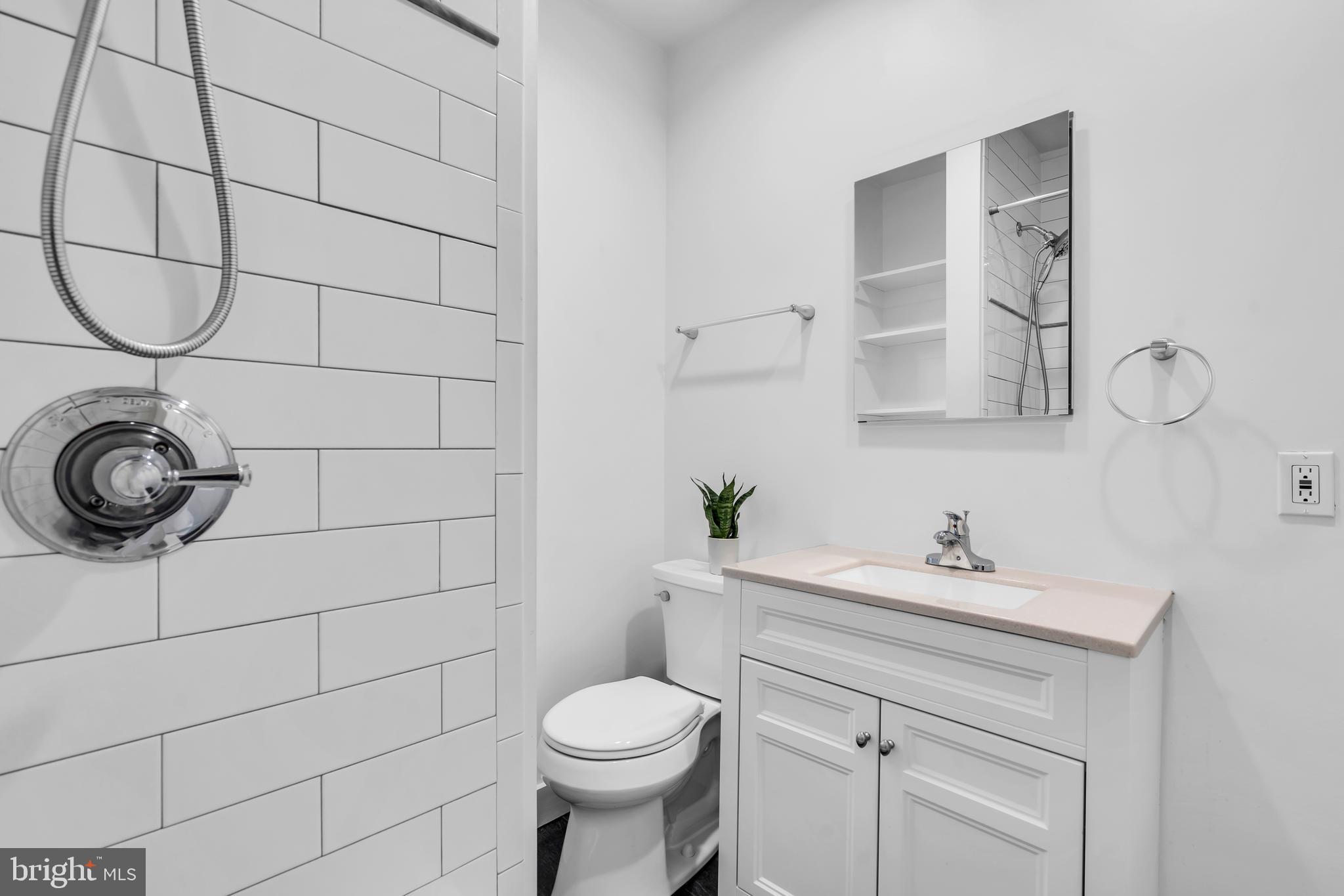 29 Saybrook Avenue Trenton, NJ 08619 - Photo 18 of 31 a bathroom with a sink toilet and a mirror