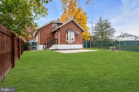 a front view of a house with yard and green space