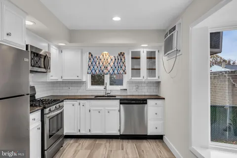 a kitchen with a sink stove and cabinets