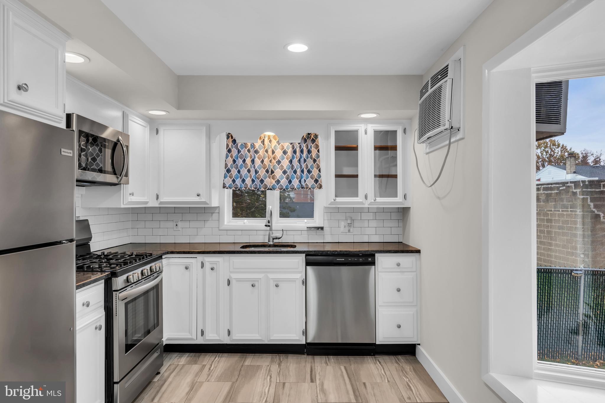 29 Saybrook Avenue Trenton, NJ 08619 - Photo 5 of 31 a kitchen with a sink stove and cabinets