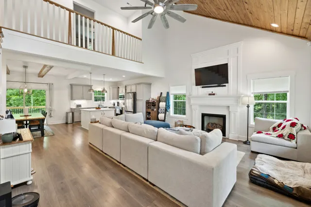 a living room with furniture fireplace and flat screen tv