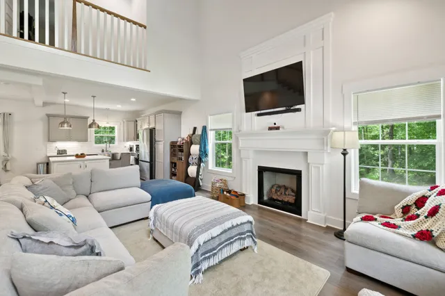 a living room with furniture and a chandelier