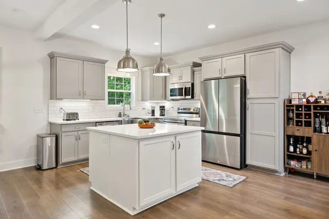 a kitchen with a sink and large window