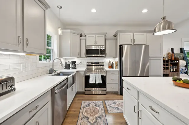 a view of a hallway with a chandelier and fireplace