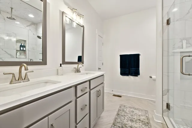 a bathroom with a double vanity sink and a mirror