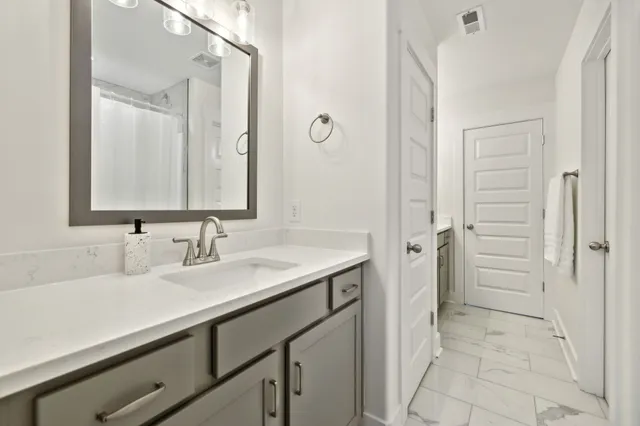 a living room with furniture a large window and a chandelier