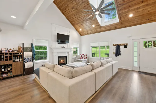 a living room with furniture fireplace and a flat screen tv