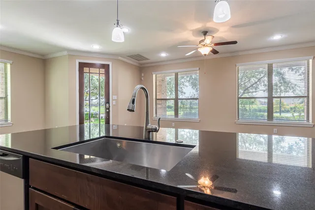 a kitchen with stainless steel appliances a stove sink microwave and cabinets