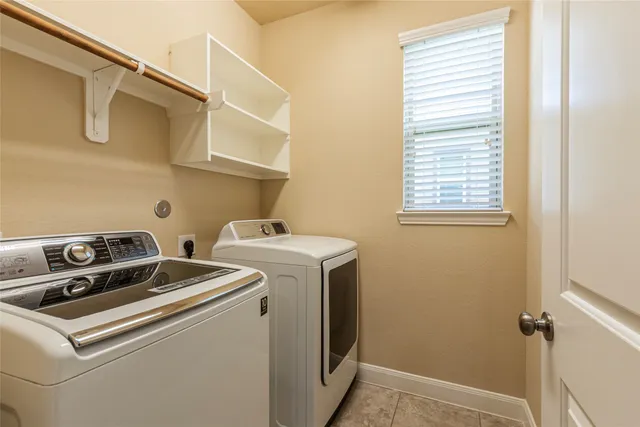 an empty room with closet and a chandelier fan