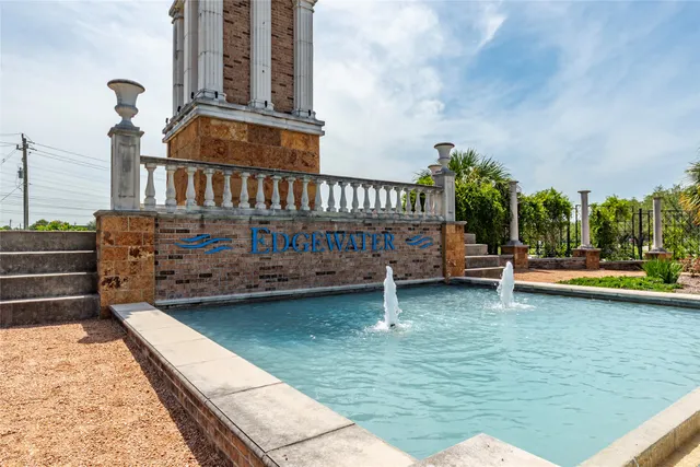 a view of swimming pool with outdoor seating and garden