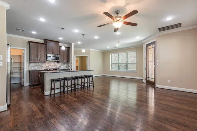 a view of kitchen with sink microwave and refrigerator