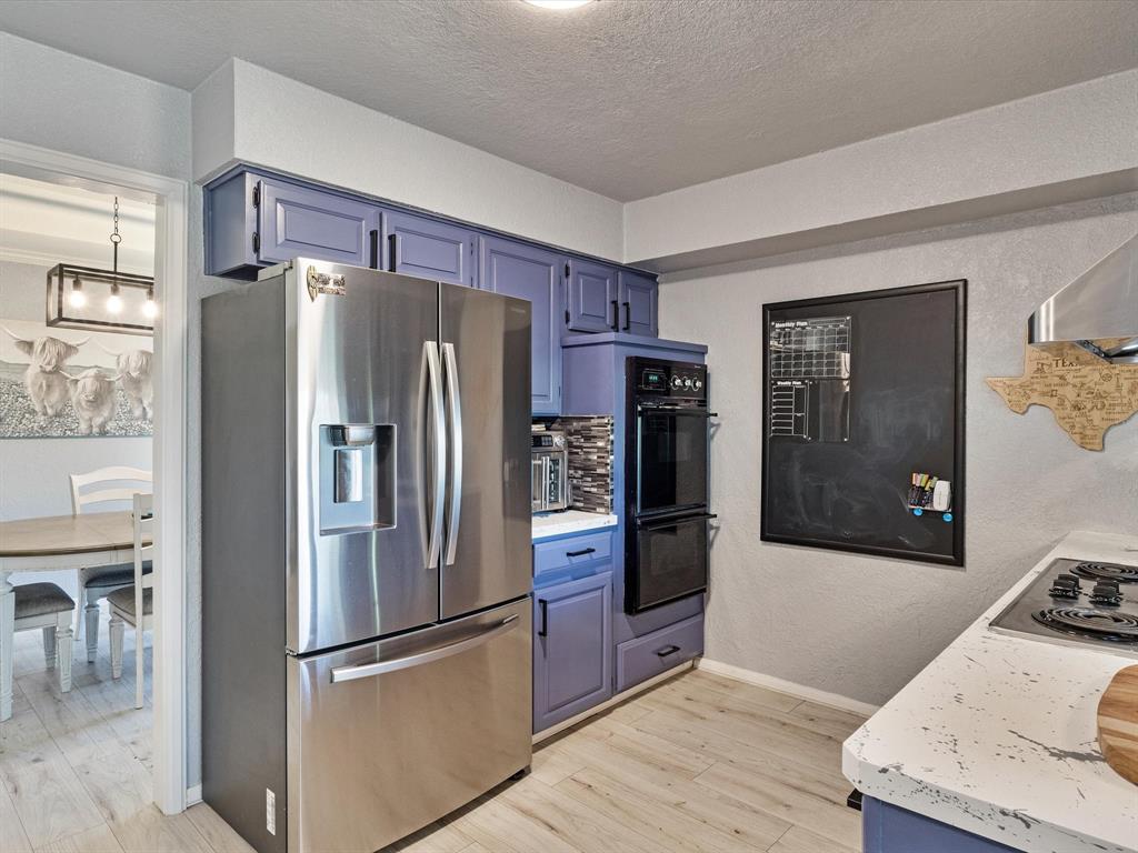 108 Sunview Street Sunnyvale, TX 75182 - Photo 21 of 29 a kitchen with stainless steel appliances granite countertop a refrigerator and a stove top oven