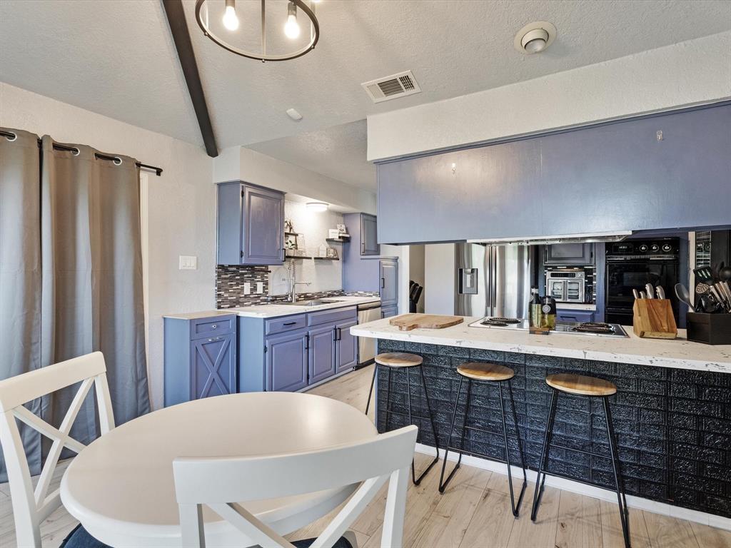 108 Sunview Street Sunnyvale, TX 75182 - Photo 26 of 29 a kitchen with stainless steel appliances granite countertop a sink a stove a refrigerator cabinets and chairs