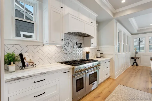 a kitchen with stainless steel appliances granite countertop a stove and a sink