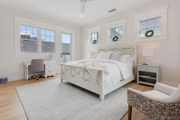 a bedroom with a bed a table and painting