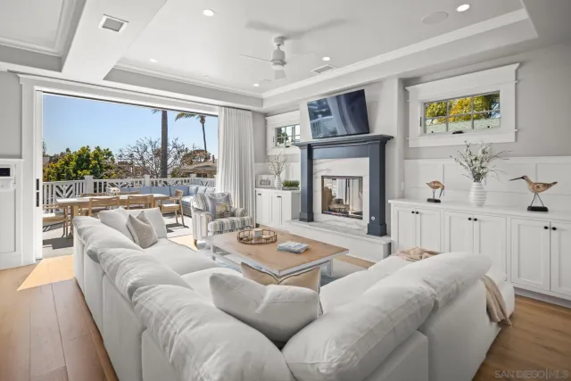 a living room with furniture fireplace and a large window