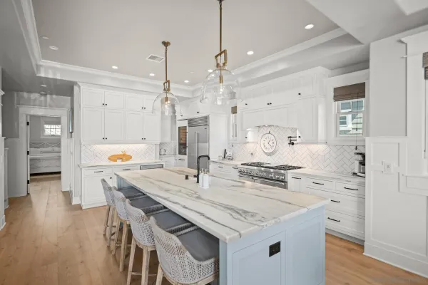 a kitchen with granite countertop a sink cabinets and wooden floor