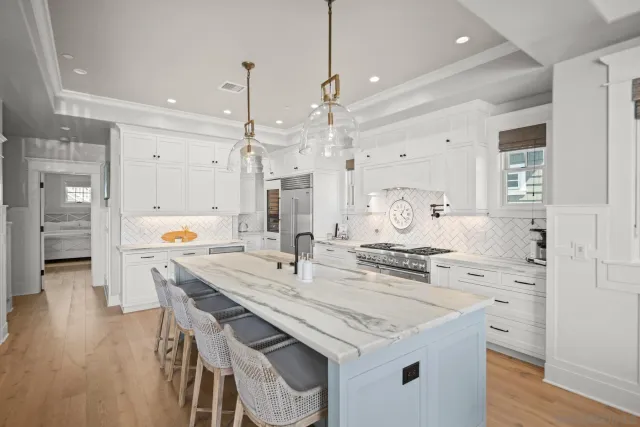 a kitchen with granite countertop a sink cabinets and wooden floor