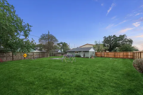 a front view of a house with a garden and yard