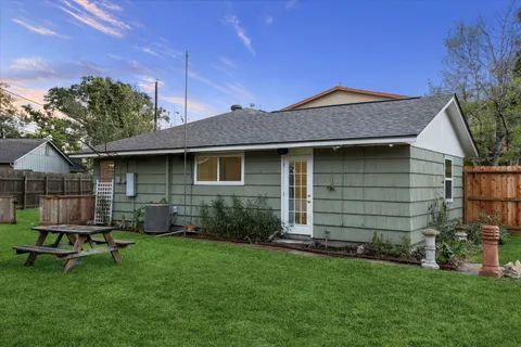 a view of a house with a yard and deck