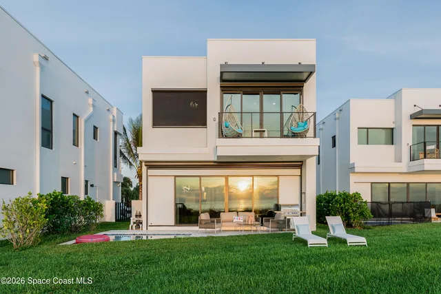 a front view of a building with garden and porch