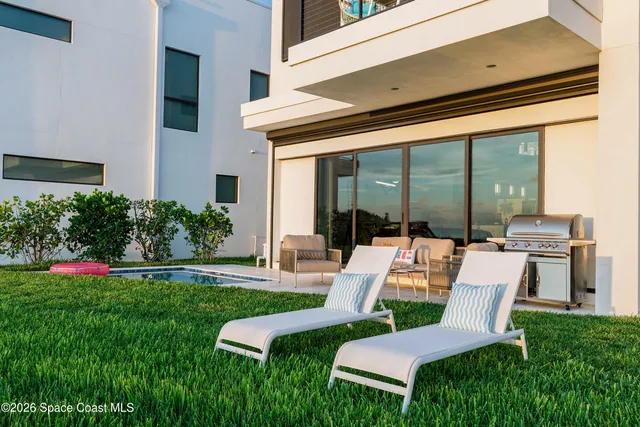 a view of a chair and table in the backyard