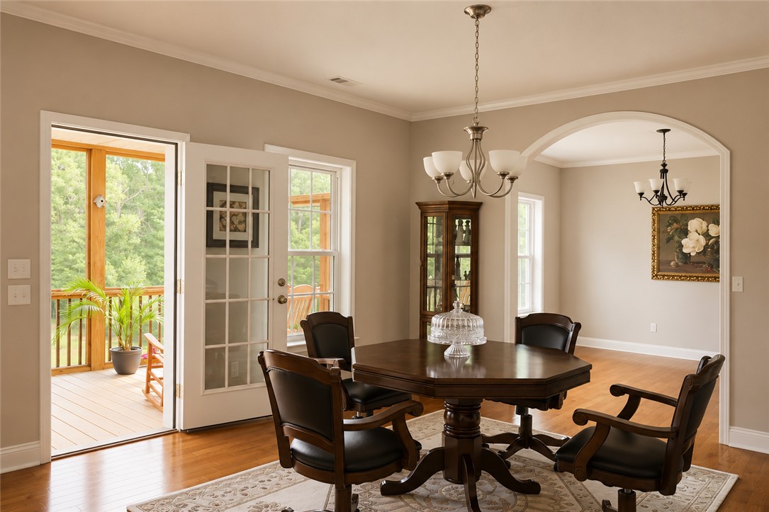 190 Fred Bradford Road Iva, SC 29655 - Photo 13 of 32 This inviting space features hardwood floors and elegant crown molding, leading to a charming outdoor deck.