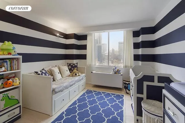 a living room with a couch and a bookshelf
