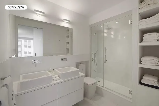 a bathroom with a sink toilet and shower